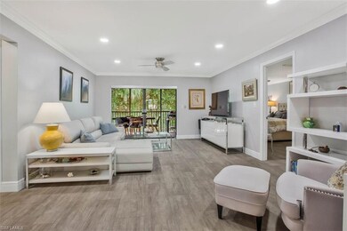 Living room featuring ornamental molding, light ha