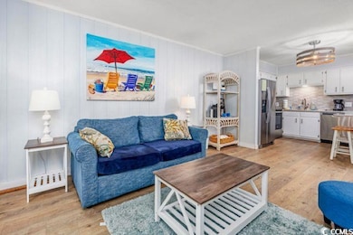 Living room featuring light wood-type flooring and crown molding