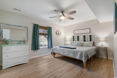 Bedroom featuring light wood finished floors, a ce