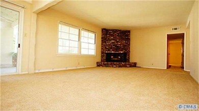 Large living room with fireplace. Plenty of light.
