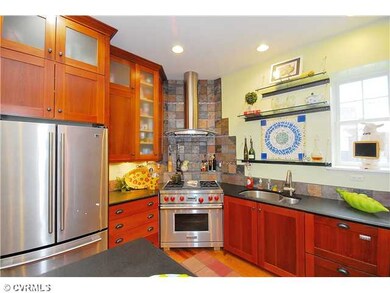 Kitchen - The kitchen has hardwood floors, honed g