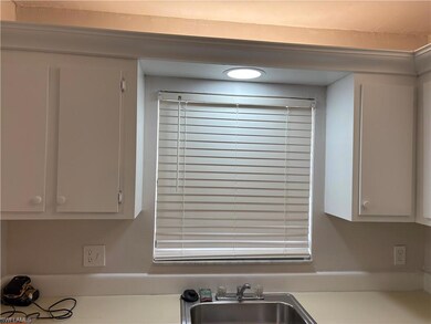 Kitchen view of light countertops and a sink