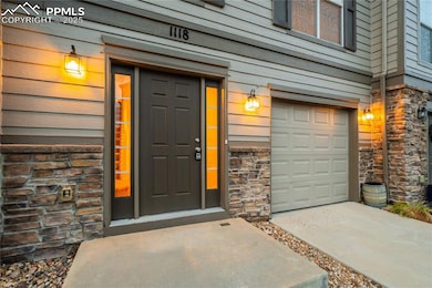 Doorway to property featuring stone siding