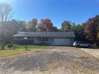 Ranch-style home with a garage and a front yard