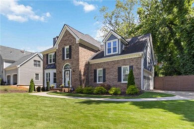 View of front of property featuring brick siding and a garage