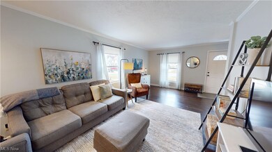 Living room featuring hardwood / wood-style floors and ornamental molding