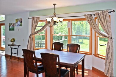 Large eating area with bay windows and hardwood fl