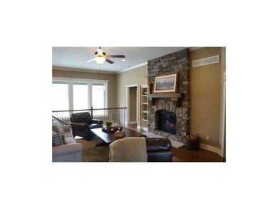 Light & bright Great Room with stone fireplace.