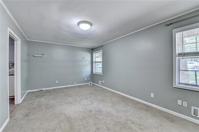 Unfurnished room with crown molding, carpet, and b