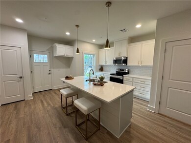 Kitchen with stainless steel appliances, dark wood