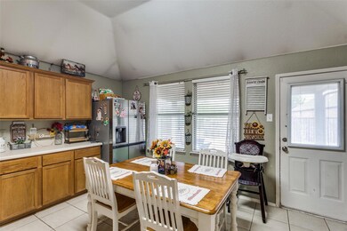Kitchen with lofted ceiling, stainless steel fridg
