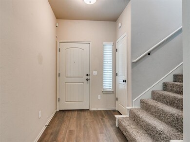 Entrance foyer with wood-type flooring and stairs 