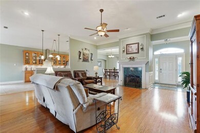 Large open concept living room features gas firepl