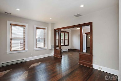 Living room - opens to dining room. Hardwood floors, high ceilings.