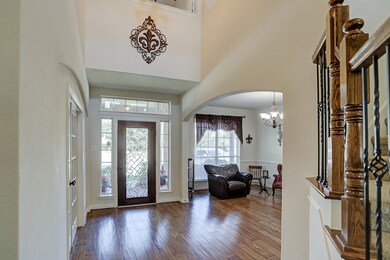 Inviting two story entry with beveled glass mahogany front door.