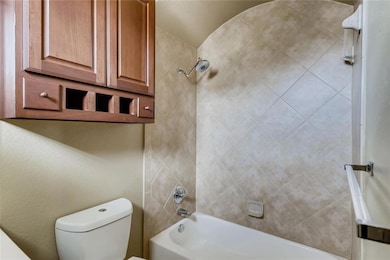 Full bath with shower / tub combination and toilet