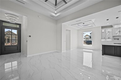 Unfurnished living room featuring marble finish floor, baseboards, visible vents, and a raised ceiling