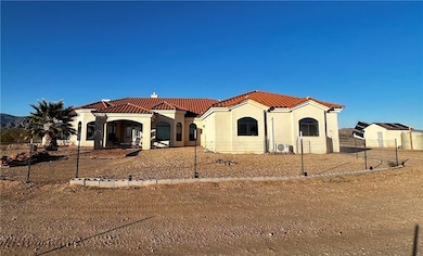 Mediterranean / spanish house featuring stucco siding and a tile roof