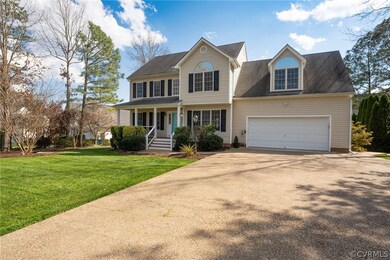 Colonial-style house with a front yard and a garage