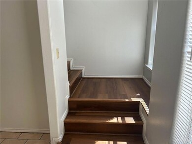 Stairs with baseboards and wood finished floors