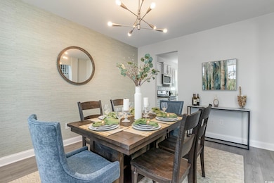 Dining space featuring a chandelier and wood finished floors