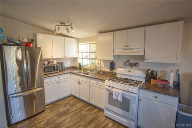 Kitchen featuring dark countertops, rail lighting,