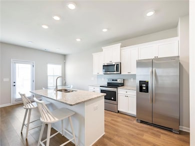 Kitchen featuring tasteful backsplash, white cabin