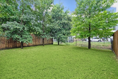 BACK YARD. The yard has a wrought iron fence and gate at the back which leads out onto a little  path.  Perfect for the dog!