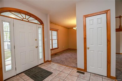 Foyer with ceramic tile, stained wood trim, and nine foot ceilings.