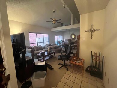 Tiled office with a textured ceiling, ceiling fan,