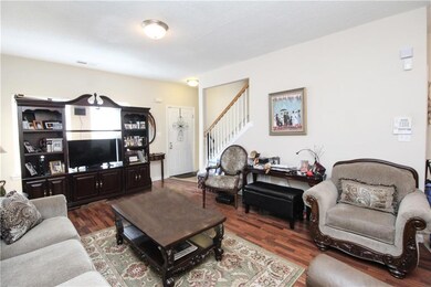 Living area featuring wood finished floors and sta