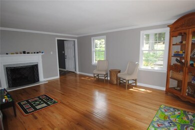 The living room is light and bright with hardwood 