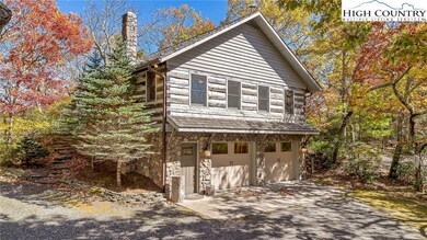 Circular driveway leads down to the lower level 2-car garage with easy access to the main cabin.