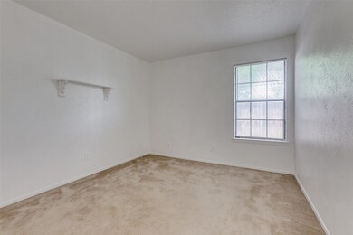 Empty room with light carpet and baseboards
