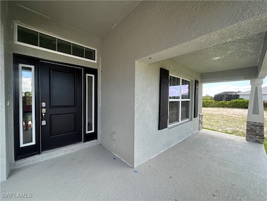 Entryway to property featuring stucco siding