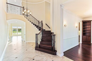 Natural stone tile, laid on a diagonal with Granite inserts, handsome wood, stately iron and intentional architectural detail create the foundation of design for this substantial home.