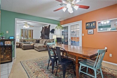 Dining room featuring ceiling fan, light tile patt