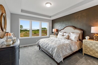 Find your retreat in this stunning primary bedroom. Enjoy the exclusivity of a private bath and huge walk-in closet. (Photo of a decorated model, actual homes finishes will vary)