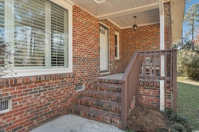 Doorway to property featuring a porch