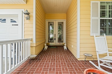 Doorway to property with french doors and covered porch