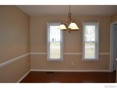 Formal Dining Room with chair rail and hardwood fl