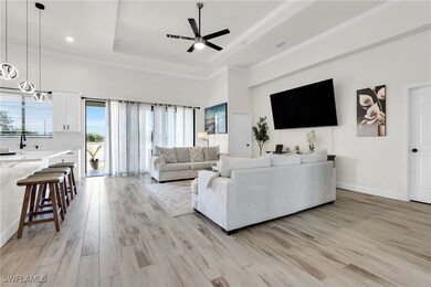 Living area with ornamental molding, a tray ceilin