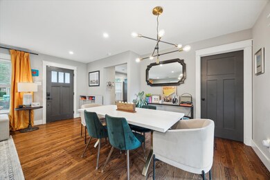 The dining area is highlighted by a modern light f