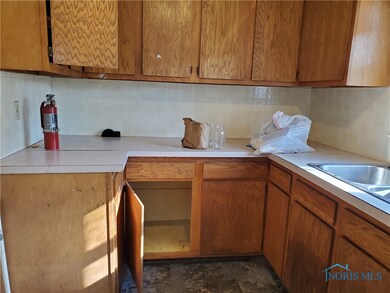 Kitchen with tons of wood cabinets and counters