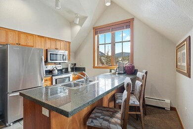 Kitchen with lofted ceiling, sink, a textured ceil