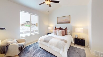 Carpeted bedroom featuring baseboards, lofted ceiling, and ceiling fan