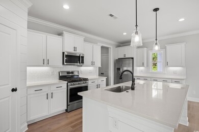 Kitchen with stainless steel appliances, a sink, l