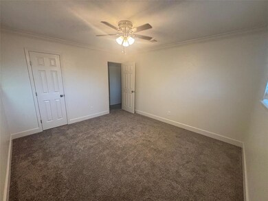 Unfurnished bedroom with crown molding, carpet, a