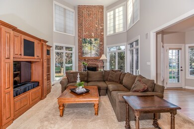Family Room with a Soaring Two Story Brick Firepla