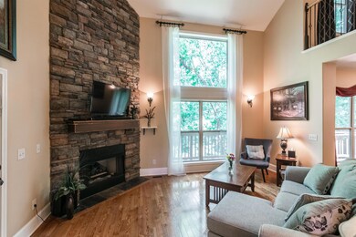 Floor-to-ceiling widows and a gas fireplace that you will want to entertain around.